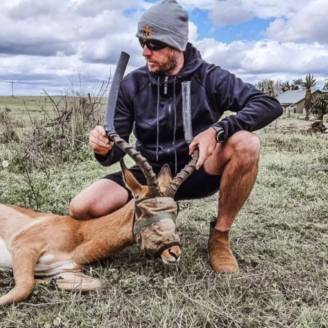 Ashley holding the horns of a buck