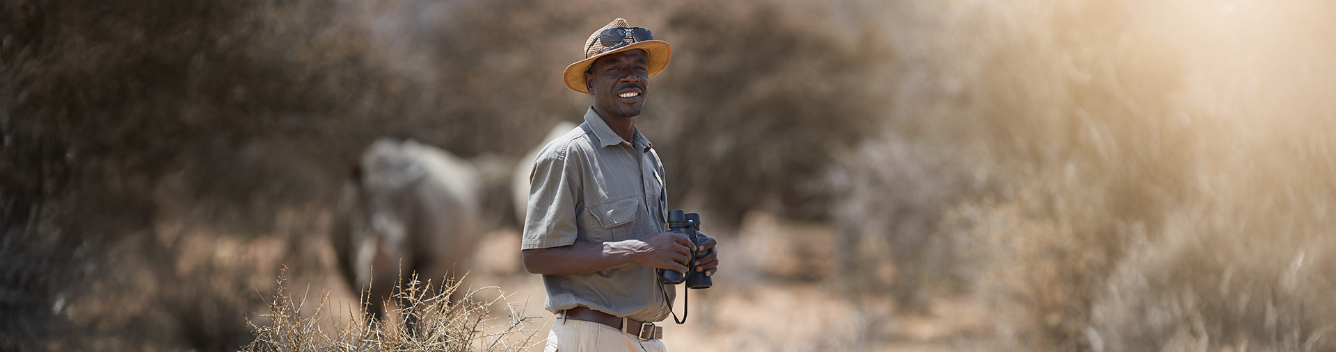 Game ranger holding binoculars
